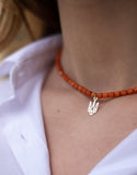 One string terracotta coral necklace, silver trident